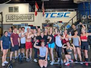Group of athletes smiling after a summer conditioning workout at TCSC