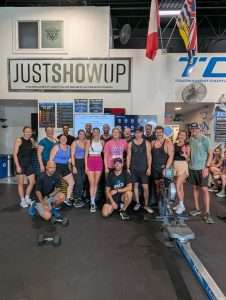 TCSC members high-fiving after class, smiling and celebrating their workout together.